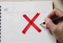 Uma pessoa marcando um calendário com um 'X' vermelho, simbolizando a consistência e a disciplina diária alcançada.